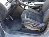the interior of a car with the door open showing the driver ' s seat
