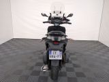 a motorcycle that is parked in a room with a checkered floor