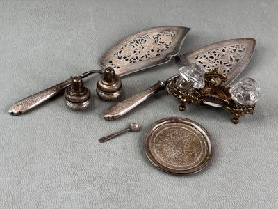 a small silver object with a coin next to it