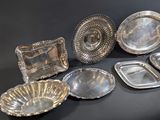 a lot of silver dishes on the table