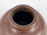 a brown vase that is sitting on a table