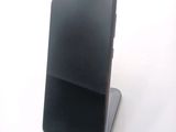 an image of a cell phone on a stand on a white surface