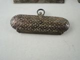a small metal object on a table next to a mirror