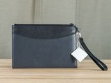a black leather wallet with a tag attached to it