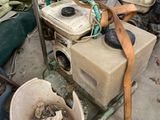 a pile of junk in a garage with a bucket and a hose
