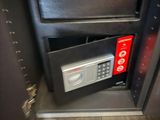 a safe box in the corner of a cabinet