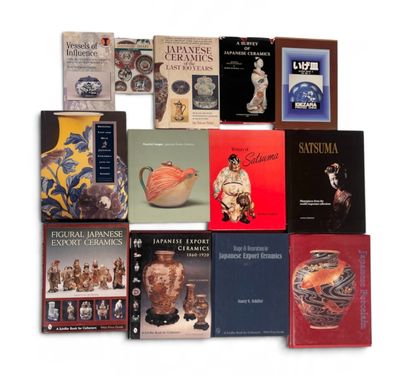 several books are stacked on top of each other on a white surface