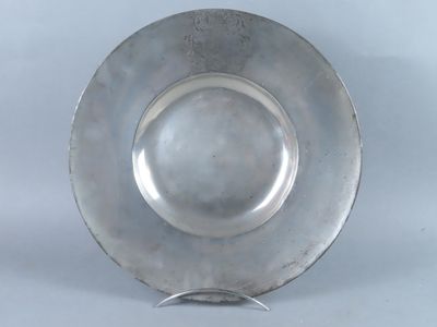 an antique silver plate on a stand on a white background