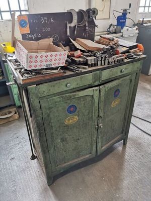 a green cabinet with a bunch of boxes on top of it
