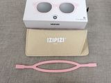 pink sunglasses and a pair of sunglasses are sitting on a table