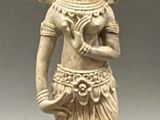 an image of a statue of a woman holding a bowl