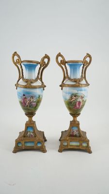 pair of blue and gold vases with flowers and birds painted on them