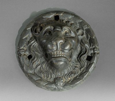 a close up of a lion ' s head on a wall