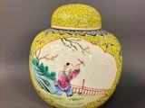 yellow and white vase with a woman sitting on a bridge