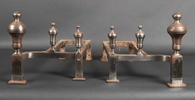 three metal candles are sitting next to each other on a table