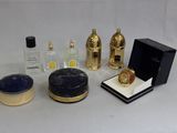 a lot of perfume bottles and a box on a table