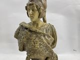 an image of a statue of a woman with a helmet on her head