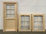 three wooden windows are lined up against a white wall