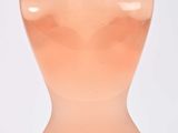 bottle of pink liquid with a silver top on a white surface