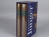 the two books are in a blue box on a white surface