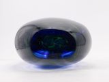 an image of a blue glass object on a white surface