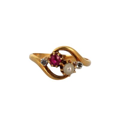 a close up of a gold ring with a pearl and a ruby stone