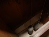 three bells hanging from the ceiling of a room