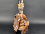 an image of a wooden sculpture of a man sitting on a chair