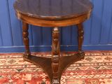 a small table with a wooden top on a rug