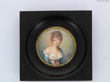 portrait of a woman in a blue dress, framed in a black frame