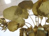 a vase with a bunch of gold flowers in it