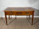 a small wooden table with two drawers on it