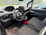 the interior of a small car with a steering wheel and dashboard