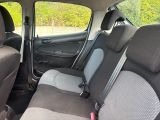 the back seats of a small car are grey and black