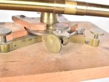 a close up of a brass telescope on a wooden stand