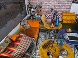 a room with a couch, a table, a lamp, and a picture on the wall