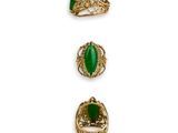 a set of three gold and green rings