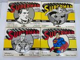 four superman comics stickers are on a white surface