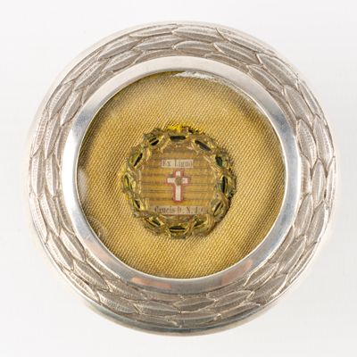 a silver and gold locke with a cross in the center