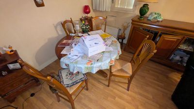 une table de salle à manger sur laquelle sont posés tout un tas de papiers