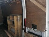 a white van with a wooden table in the back of it