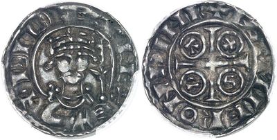 a close up of two silver coins on a white surface