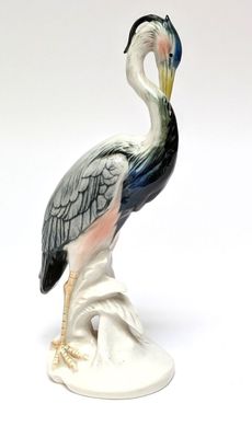 a figurine of a bird that is standing on a rock