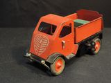 a red toy truck that is sitting on a black surface