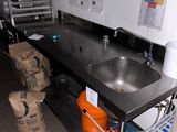 a kitchen with a sink and a lot of items on the counter