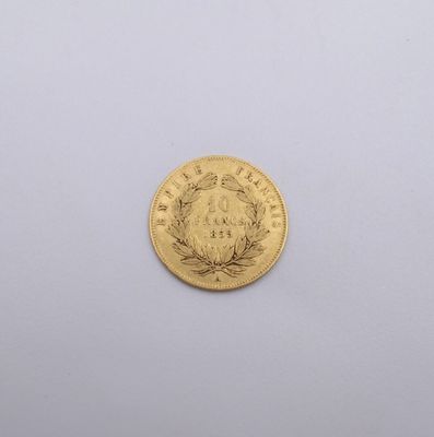 a close up of a gold coin on a white surface