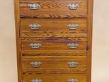a wooden chest of drawers with four drawers on each side