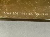 a close up of a gold plate with writing on it