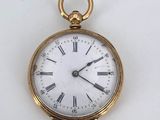 a gold pocket watch with roman numerals on the face