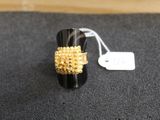 a close up of a ring on a black surface with a price tag